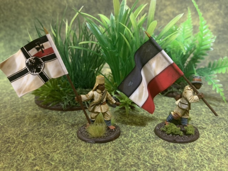 Both flag bearers are from Brigade Games. The flags are from Flags of War. On the right is the national flag. On the left is the military or Reichskriegsflagge.  