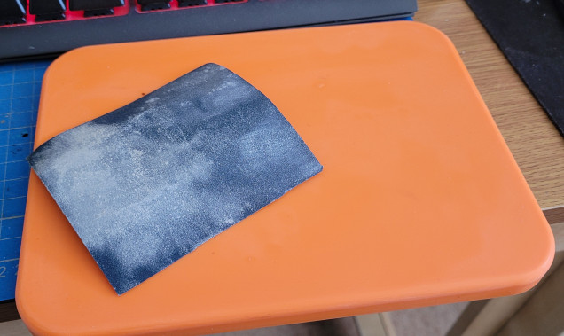 The orange needs to go, it'll clash with the sticker. The surface needs scuffed up a bit before priming. 160 grit paper