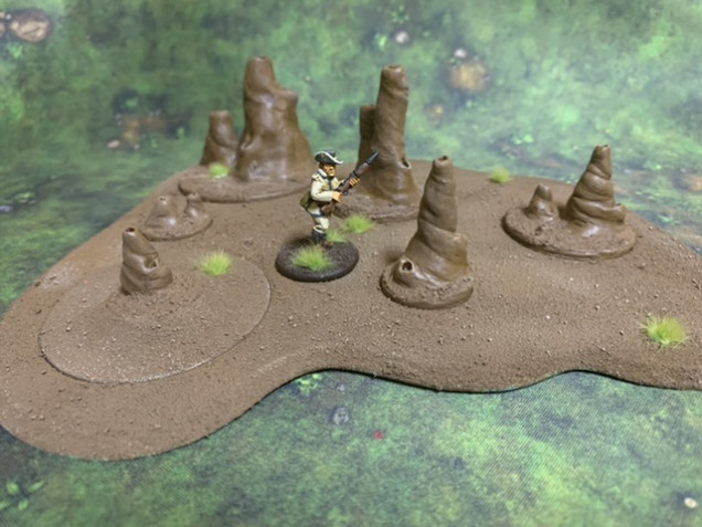 Resin termite mounds on MDF bases. 