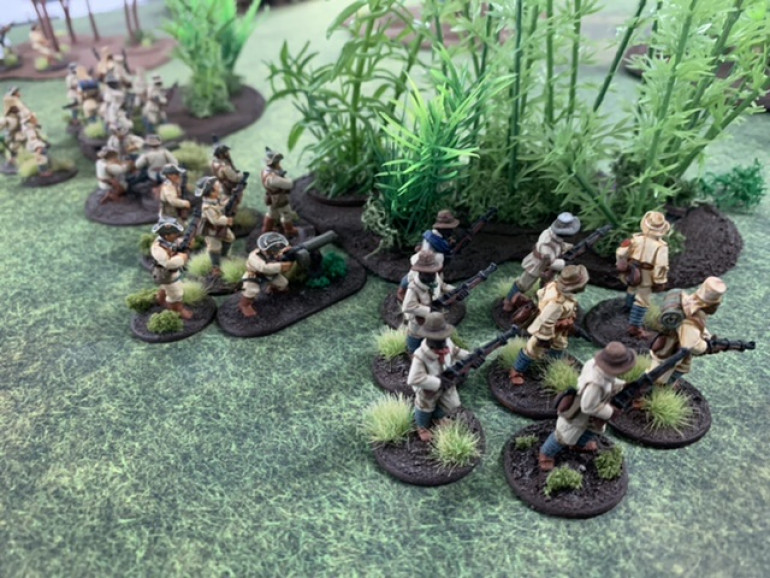 The German right flank uses the jungle as cover to approach another objective. The commander and HMG team are in the center ready to lend support on either flank.