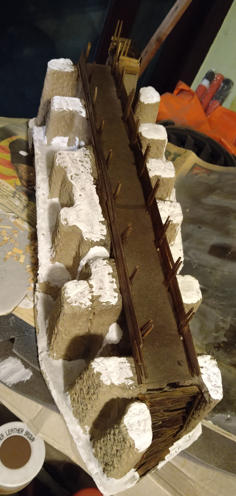 I decided that I should try to tidy the edges of the packaging with some filler. This was done with PVA, plaster, drop of black paint and some some stones.