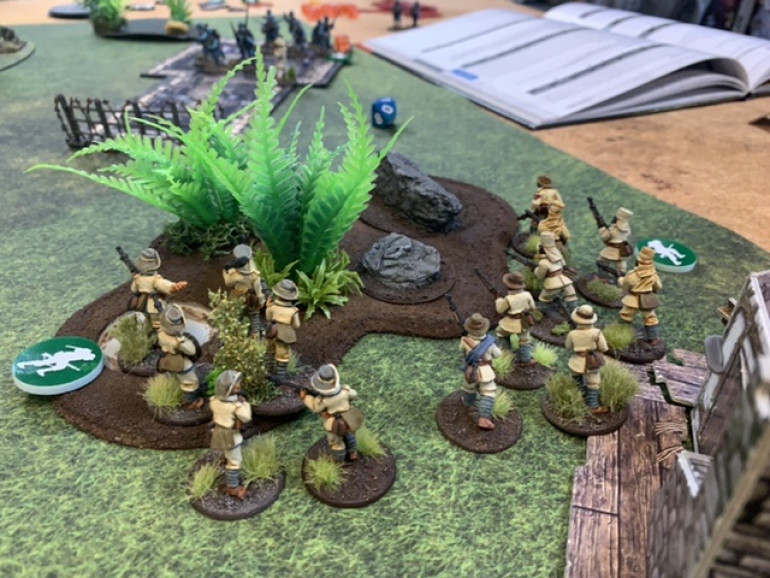A small Schutztruppe squad moves into the jungle to provide suppressing fire while an Askari squad uses cover to move into assault positions. 