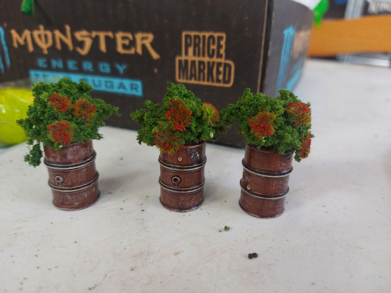 A quick re-purpose of some old GW 40k scatter terrain gave me these cute barrel planters to go in the town square. 