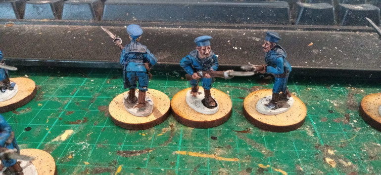 Caledor Blue highlights on all the Jackets and Trousers followed by a Kislev Flesh Skin Highlight
