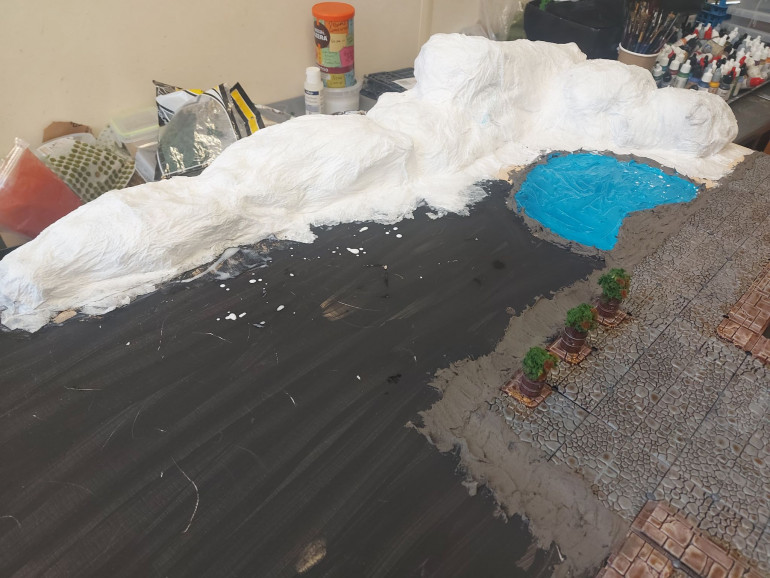 Next steps were tackling the paper mache on the paper scrunches to make hills and slopes, and using a combination of earth texture and more paper mache to create smooth transitions between the street panels and the rest of the board. 