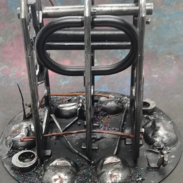 The metal ovals are medicine pill blisters packed with bits of sprue and glued down. The pipe work is a plastic straw. The cables between frames and the across the floor are heat stretched plastic sprue. There's also a shower curtain rail hook.