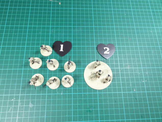 Tokens next to some metal Bolt Action Italians