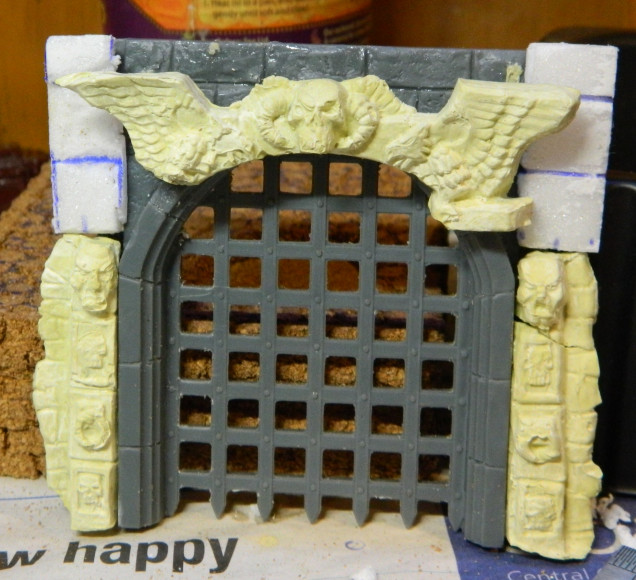 22 Sep 22: Putting the pieces together. A plastic portcullis from the Renedra Tower set, WHQ door mold using Milliput this time and foamboard to finish it off front and back.