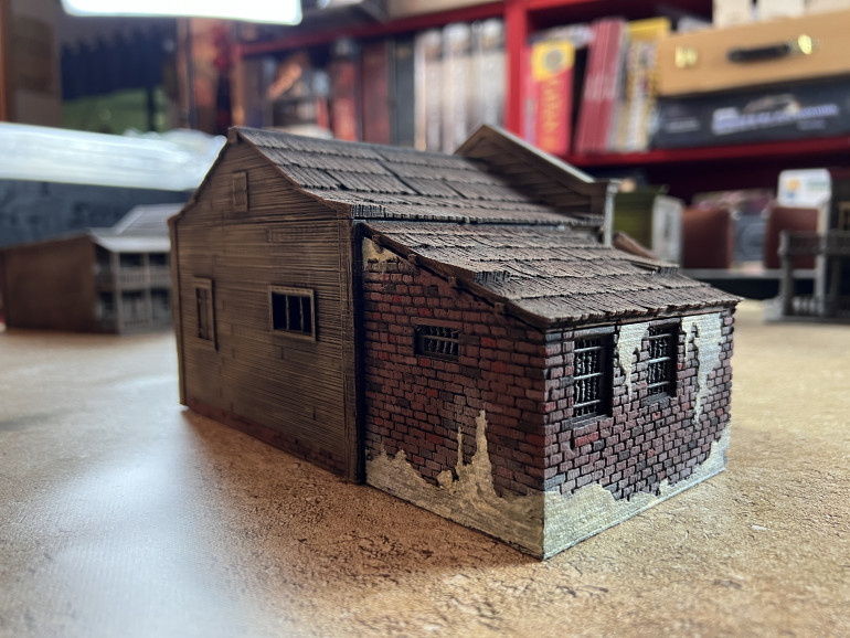 The jail has a fair amount of cracked plaster over the bricks, which I quickly treated with craft white paint and dry brushed white paint, covered with a sepia wash. For bricks painting details, see my MCP project.