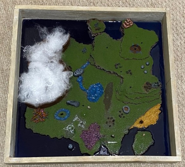 After giving the resin 24 hours to cure, the piece was finished by using PVA glue to apply artificial snow on the North West of the map. This represents the Wyrdness that blankets cursed Tuathan.