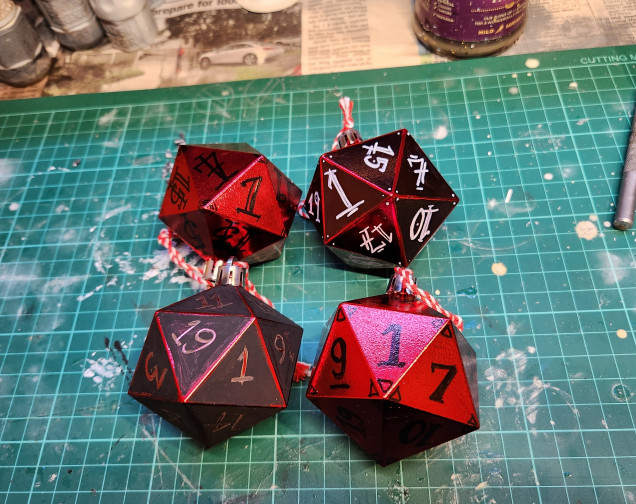 The four that will go to the D&D party, one each. Permanent marker, black acrylic paint, bronze Sharpie, white Posca pen