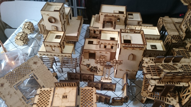 I decided a couple more buildings were required. I had always like the aesthetic co-opted by GW in their Necromunda franchise, but obviously their prices were....their prices. Therefore I made thoroughly nice Ebay vendor the Troll Trader 100 quid richer instead and then found a few other bits on also on Ebay. Four weeks later and upwards of 1500 manly swears later I had a table full of stuff to paint. 