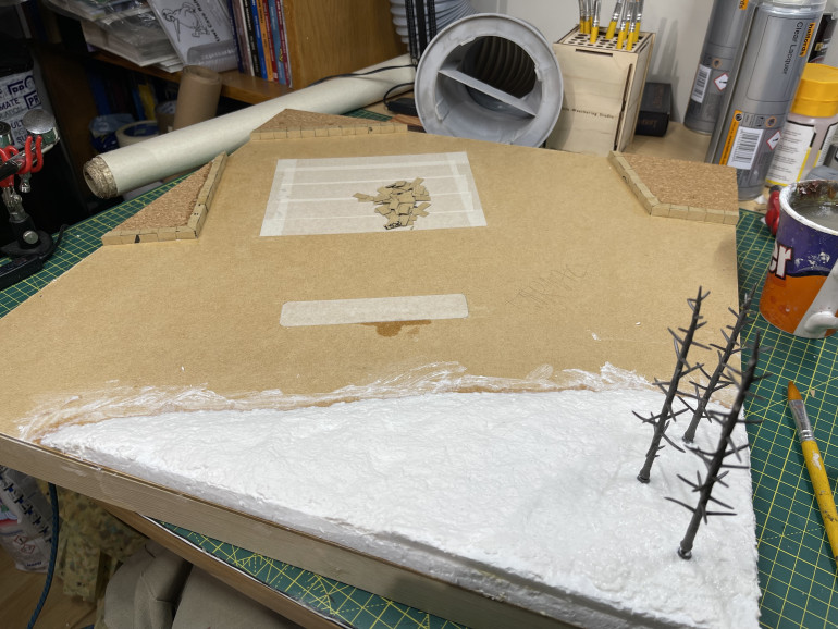 sculptamold to smooth out the hill and add woodland scenics tree armatures