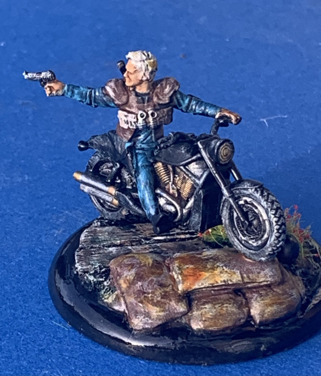 Miniature chosen: Crooked Dice Miniatures Biker A (metal) SKU MInI 174a, Sculpted by Ernst Veingart. Mounted on a resin 50mm round lipped trench base from Secret Weapon. 