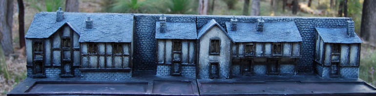 After under-coating in a dark chocolate brown I used creams and off-white paint from the local hardware shop to dry-brush the model.    The wooden beams were painted with black ink from an Art store.