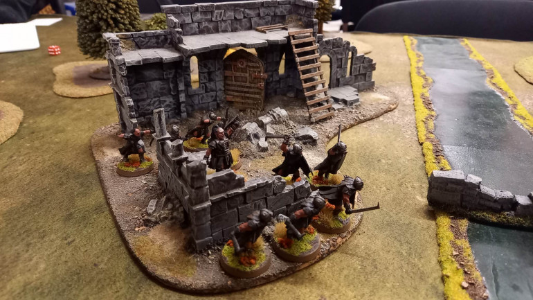 Lurtz took cover in some ruins and shot down at the Hobbits approaching from the other side.