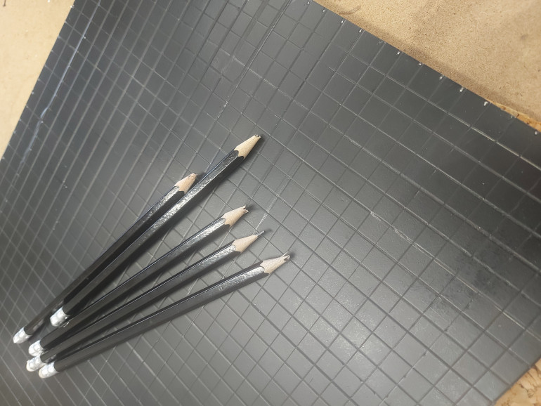 I've had a think and I have an idea of how I want the scene to look. It'll be a big ballroom filled with cool scatter, with a grand staircase leading to a balcony as the focal point. I cut a base and sprayed it black, and marked a grid of cm². I killed soooooo many innocent pencils doing this. 