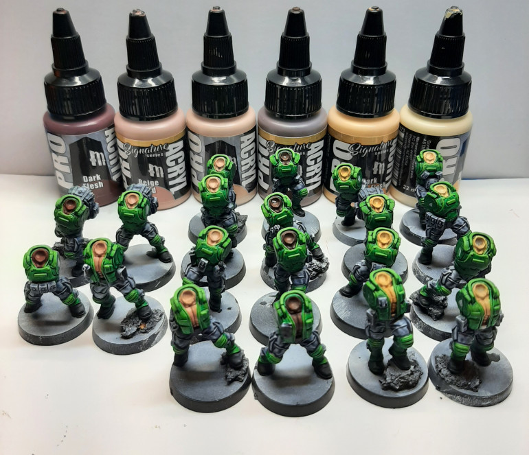 I set out a few colors that could pass as skin tones, giving me some more variety within the squad.  I could not live with the green, so I highlighted the speedpaint with a lighter shade of straight acrylic. I felt much better about it.