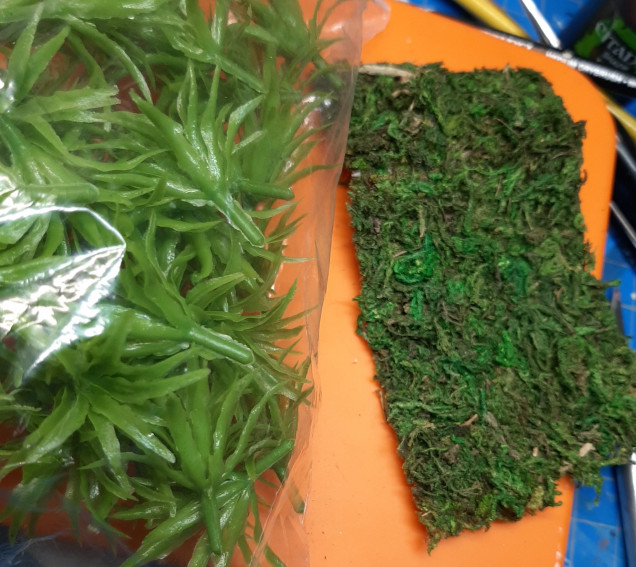 I got a bag of green plastic plants from Amazon for a few bucks and found a moss mat at a local craft store.  