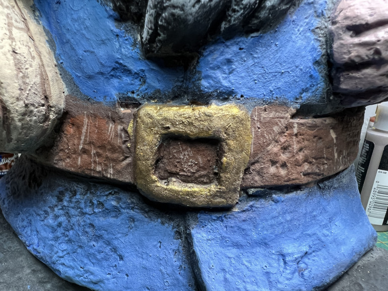The belt was painted in leather tones and weathered as a 28mm miniature belt would, with scratches and use marks.
