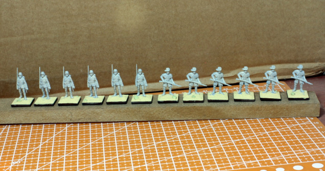 Figures primed with an airbrush. I don't recommend doing it with a brush.