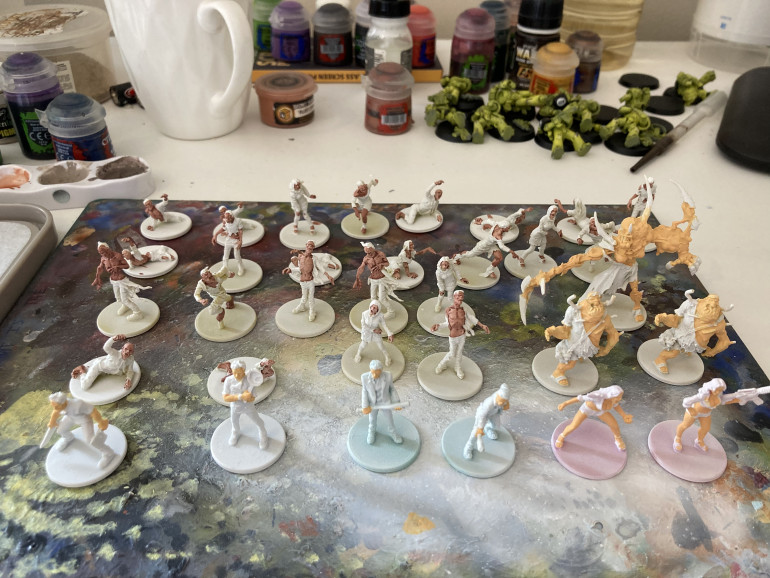 Skin tones finished for the zombies and first base coat for the fancy zombies and survivors.