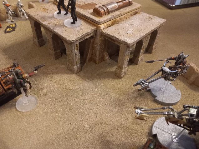 Fett gets taken down by various units before he can use all his nasty command cards. In the last turn only one stormtrooper is left. The swoop bikes over run him and take his head off.