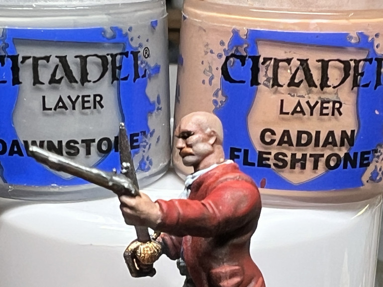For flesh, I added a layer of GW Cadian Fleshtone (two for lighter skintone). For the eyes, I added a shade of black , then a dot of white, followed by eyes created with a tiny dot of black applied with a brush (my usual marker tip was too large for the recessed sockets). Finally, I mixed a little flesh tone in some GW Dawnstone, which I then diluted before applying 5 o'clock shadows (do not forget the head for 'bold' miniatures.