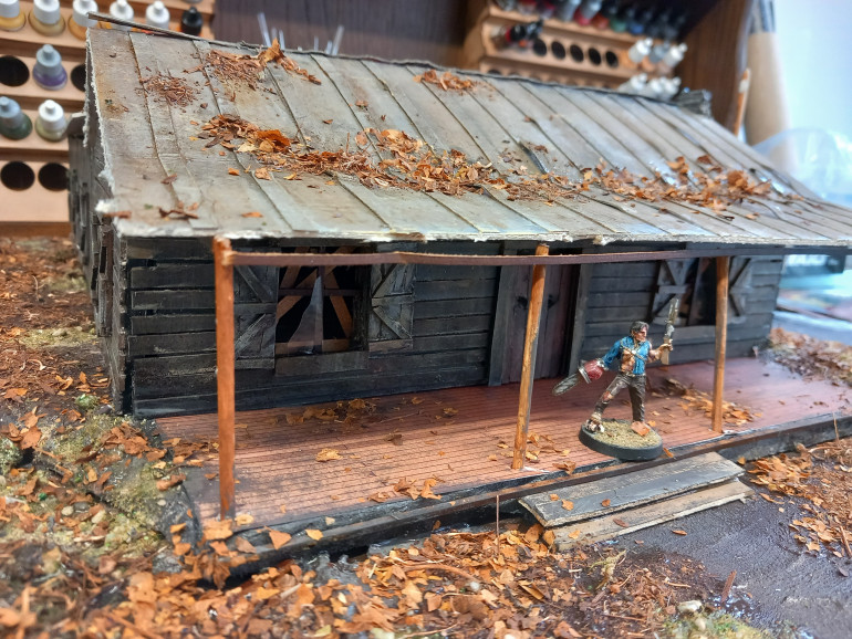 I made sure the new roof got some dirt. I've added steps to the backdoor with a woodpile. Some dead trees as well. Still more to do today.