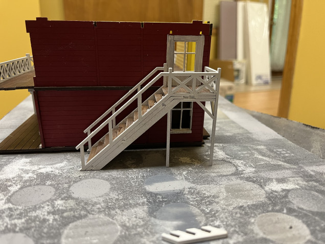 A different view of the stairs. As designed, the only contact point for the stairs will be to the floor of the second story. If glued into place the stairs would come off when you remove the second story. That’s not tenable so the stairs will have to be a separate assembly. 