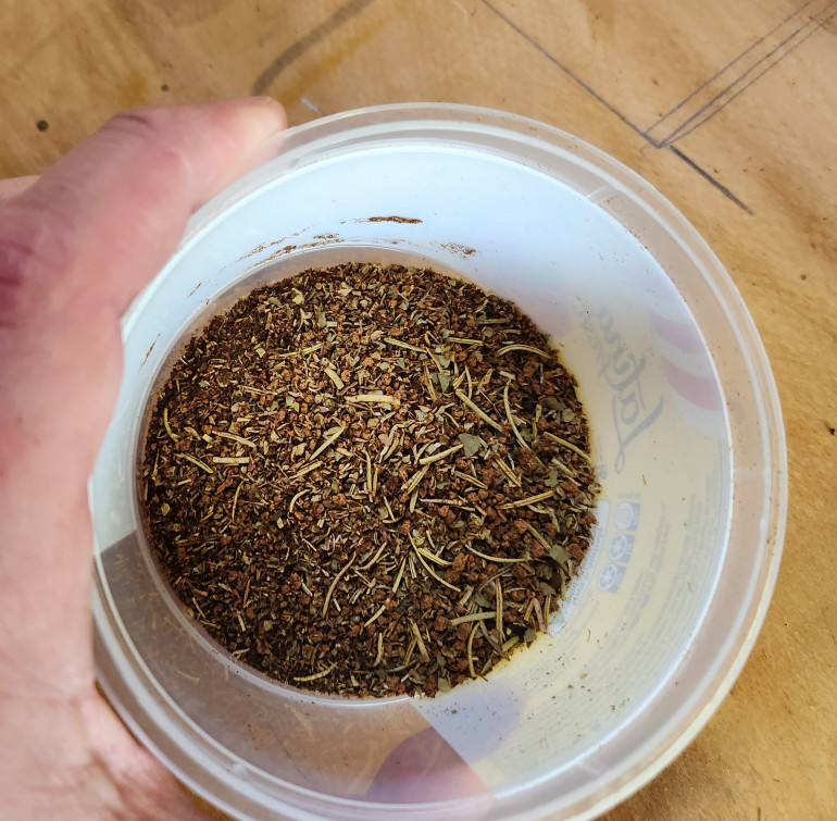 Roughly equally amounts used tea leaves, spent coffee grinds, dried mixed herbs