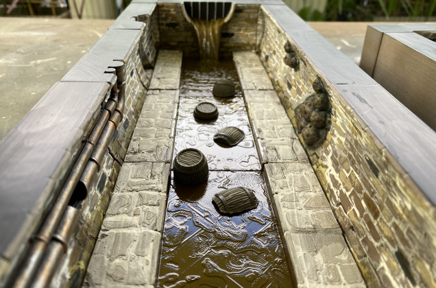 Barrels to help navigate across the foul-smelling sludge.