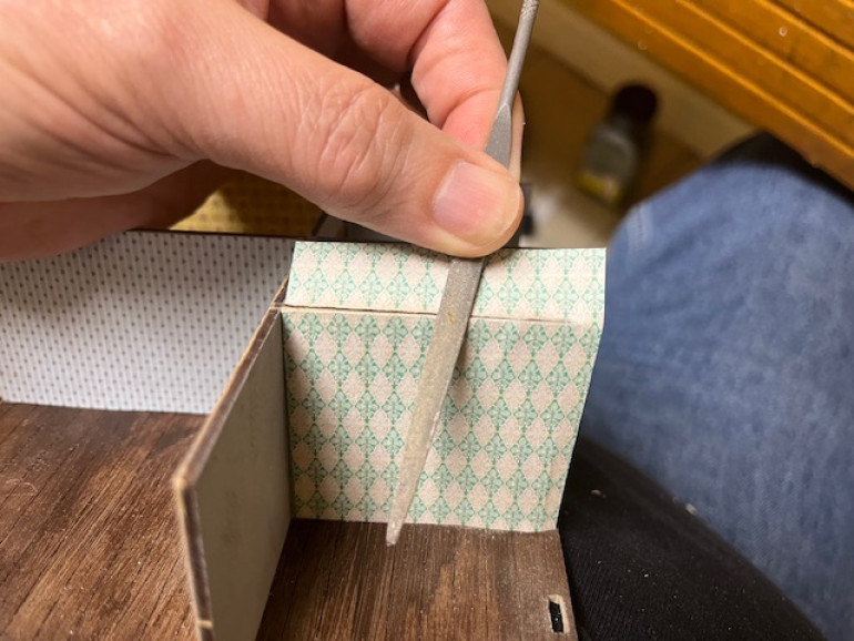 After cutting the paper roughly to shape and gluing it place, I trimmed it by using a file.