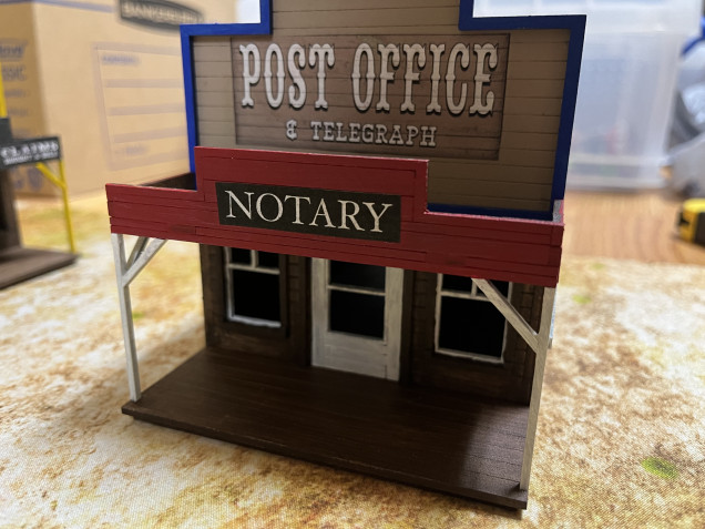 Finished up the telegraph/post office. Printed out my own Notary sign but the other signs on this and the other buildings are from a free PDF from Sarissa Precision. 