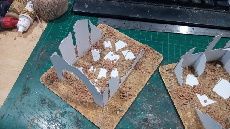 This is an older pic but it shows the ideal way to base them. First place the clumps of big rubble, I used a cork basing mix. This can be glued with normal PVA glue. Then I coated the entire base in PVA followed by Geek Gaming Scenics Desert Mix, basically anything with some big and small rocks in it will work, the goal is to break it up a bit and make it look like scattered rubble. The extra floors have a little PVA and sand where the floor meets the walls to hide the joints but also to give them a bit of bulk and not look so skinny.