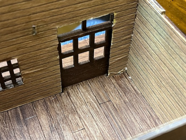 Detail of the front door. As you can see, it’s a bit ragged around the edges and down in the right hand corner. If anyone from Sarissa is reading this, there’s enough free space on the MDF board in this kit to add two more door frames. 