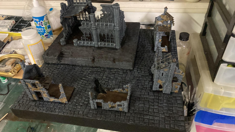 Painted up the board and put the ruins in. Need to add details and dry brush a bit more of the buildings