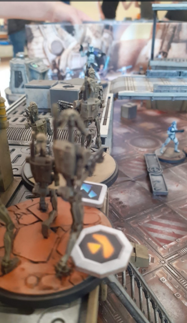 The b1 droids pour fire onto the clone troops forcing them back around the corner into cover keeping their objective secured