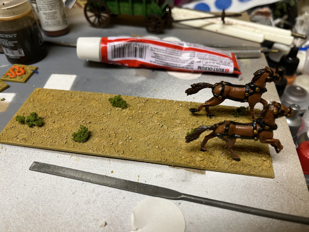 Next I drybrushed the base with Army Painter Skeleton Bone and used PVC glue to add some clump foliage. 