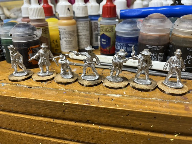 Great Escape Games minis are characterful but will require flash removal and seam removal/filing.  Glued to MDF bases, I’ll cover the bases in a basing compound to help conceal those puddle bases on the minis. 