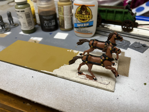 Once the glue dried, I added basing compound. Once it dries, I’ll paint it Desert Yellow, then add the sand, paint that, the finally glue the wagon back in place. 