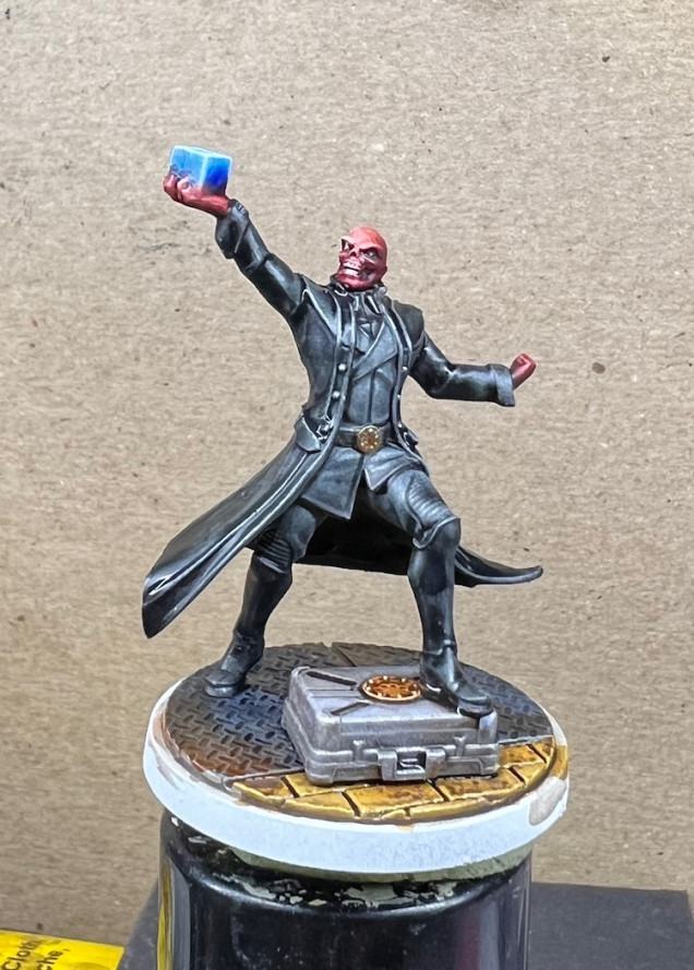 I highlighted the reds, cleaned up a few spots and added a wash of Nuln Oil to the coat and boots.