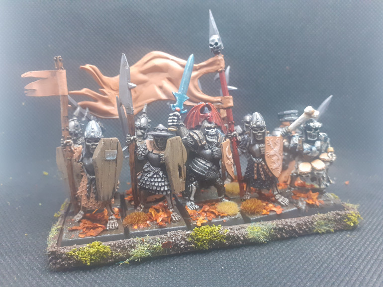 A unit of skelly bobs in heavy armour with great weapons led by a Wight. This unit also has the battle standard bearer 