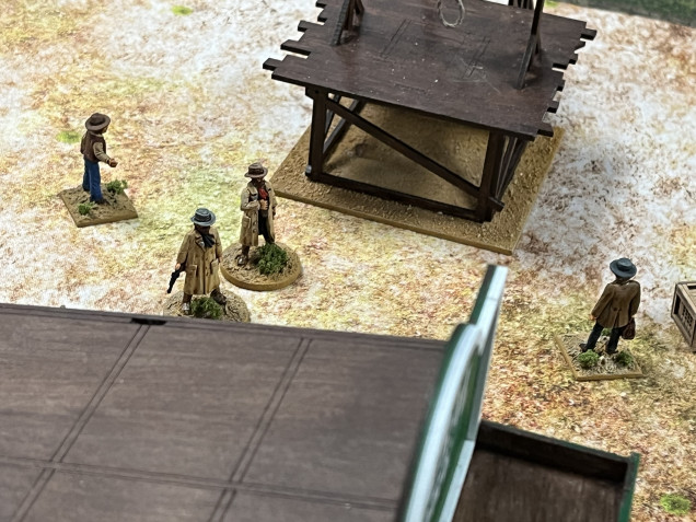 The Pinkertons move past the scaffold and …