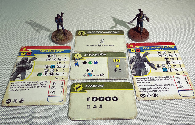 Your starting crew.  Note: the updated Fallout Wasteland Warfare rules mean that you ignore the armour values on the cards and instead only use the values of equipped armour (in this case the vault jumpsuits).  Both characters are equipped with a jumpsuit, a stun baton and a stimpak.  At the time of writing the happy but confused couple are worth 321 points.  This will influence the quality and quantity of enemies they will encounter!