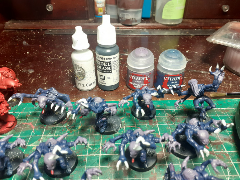 The genestealers now have kantor blue carapace purple wormy bits and corax whit claws along with mephaston red wiggly tongues. The bases are painted dark grey