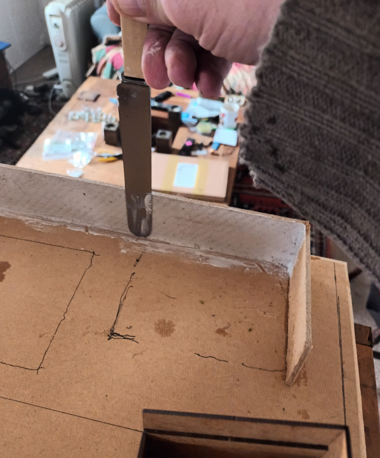 I found a large fat dinner knife perfect for plastering the walls. I also plastered all the corners and join marks on the building and walls. Once dry i sandpapered all the polyfilla.