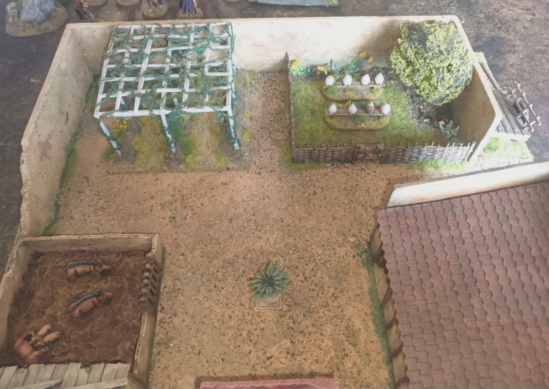 The Garden with previously built Vineyard and Beehives. The court yard has covered in fine sand and some green wash was used to blend into bottom of building.