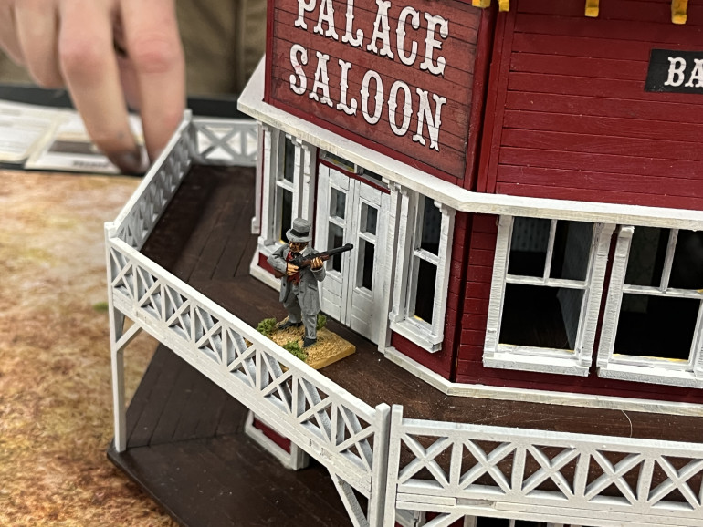 The saloon owner stands by to repel all ruffians.  .  