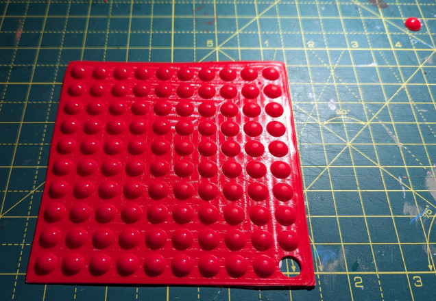 A sheet of red rubber dots